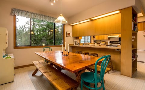 Dining area with large, hand-made table.  comfortably seats 8-10. View of bay.