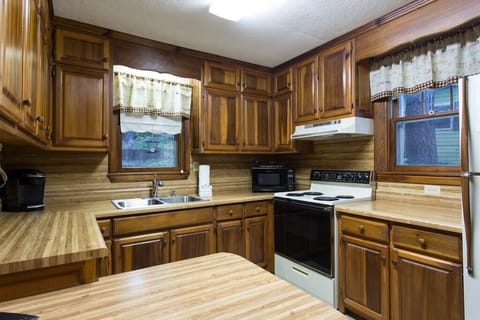 In the kitchen is an electric range, refrigerator, microwave, coffee maker, and more. With no dishe you will enjoy the view from the window over the sink