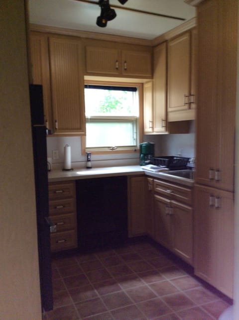 Kitchen stocked with utensils, pots and pans, dishes, etc.