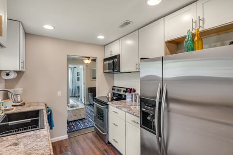 Full kitchen with stainless steele applicances and room to cook.