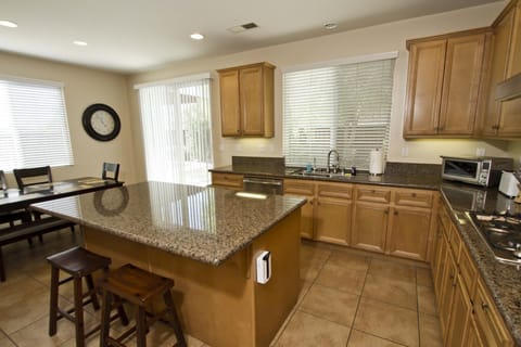 Large, fully stocked kitchen with island and stainless appliances