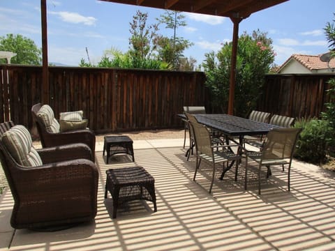 Covered patio w/ outdoor dining, sofa, etc. for enjoying the warm days and night