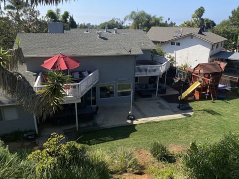 Large backyard with lots of grass, play structure, dining for 12, patio seating