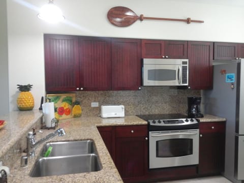 G-31 Kitchen with stainless steel appliances and granite countertops