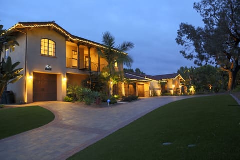 Front of guest house from street; Main house in distance