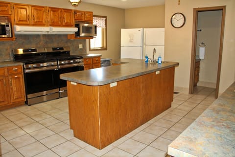 Kitchen complete with dishes and cookware. Just bring the food and the chef!