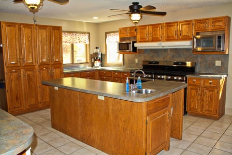 Large coffee maker, 2 microwaves, 2 fridges, and 2 gas ranges.