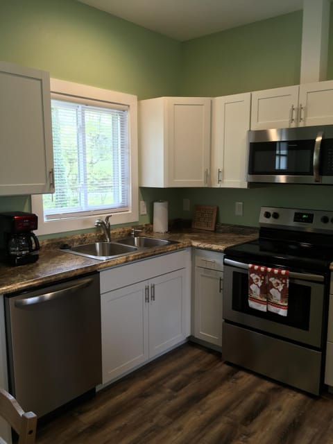 Fully equipped kitchen with dishwasher, disposal, microwave, oven and stove.