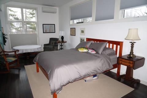 The studio has a comfortable queen sized bed and sitting area.
