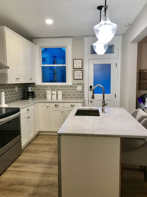 Kitchen with island that seats two and opens to dining area