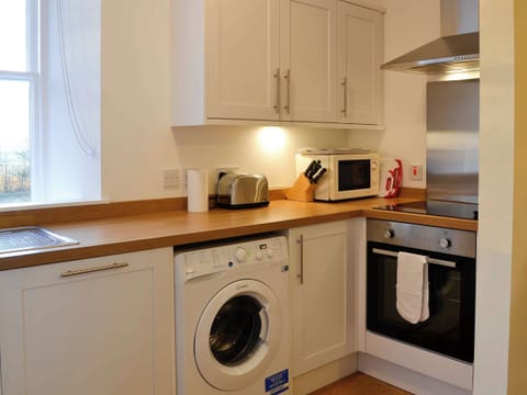 Kitchen with laundry facilities | Dairy Cottage, Whitehouse, near Alford