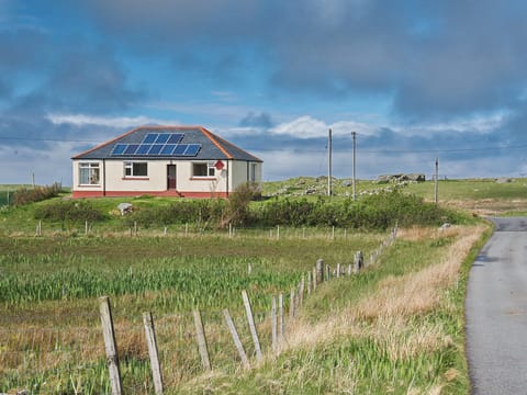 Sitting on a raised area close to the Loch Roag shore | Padraig&rsquo;s Cottage, Howbeg (Tobha Beag), Isle of South Uist