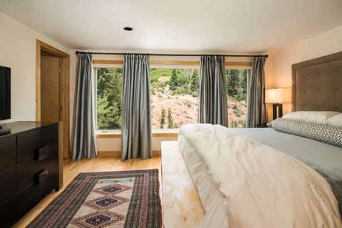 The upstairs master features a king bed, flat screen TV, and en-suite bath with shower.