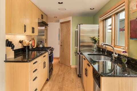 Stainless steel appliances, granite countertops, and a great view are found in the fully equipped kitchen of this condo.