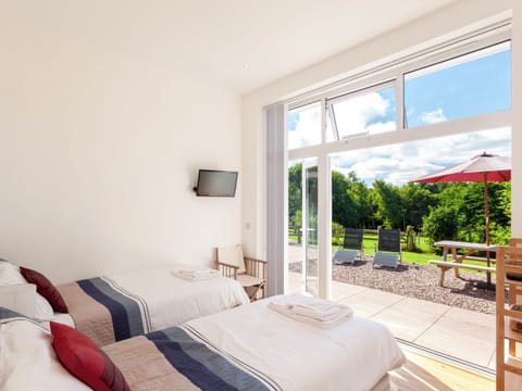 Relaxing twin bedroom with access to terrace | The Red Barn, Braunton, near Barnstaple
