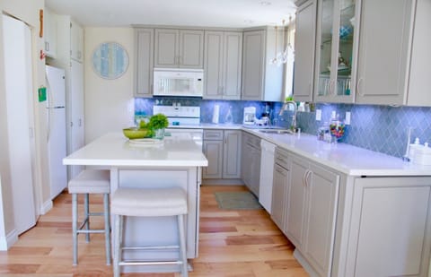 Kitchen, pantry, and a stacked, small washer/dryer combo