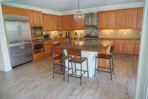 Fully stocked Kithen view from Great Room, with seating from four around island.