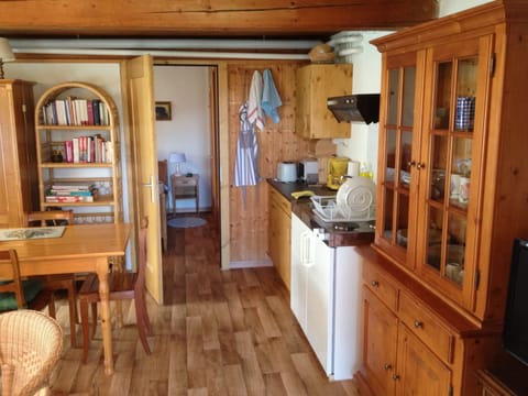 The cooking area, with a wooden cupboard for the kitchen crockery and utensils.