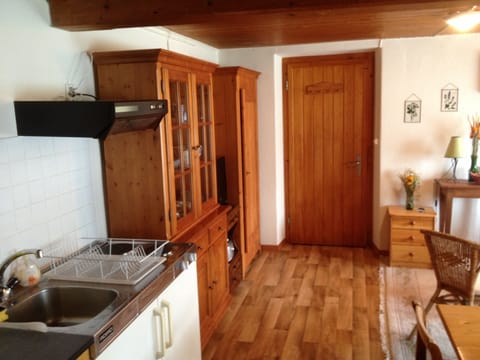 View of the living room in the direction of the front door of the apartment.