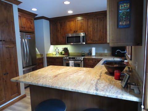 Custom alder wood cabinetry and granite counter tops.  Water purifier system.