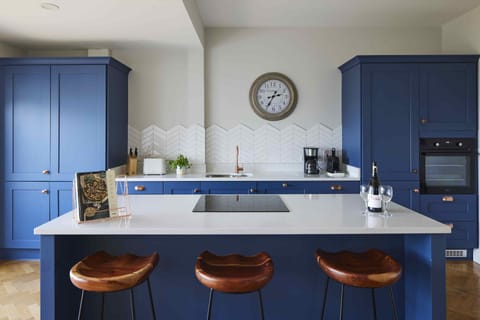 Full kitchen leading out to private deck with hot tub