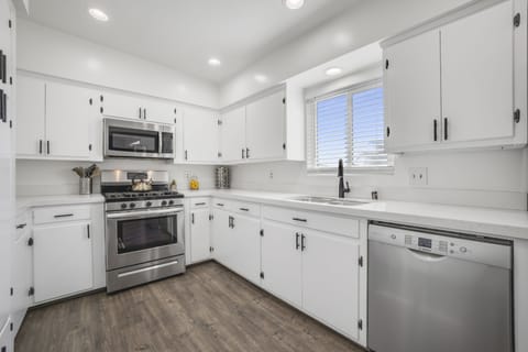 Fully stocked kitchen with gas stove, microwave and dishwasher