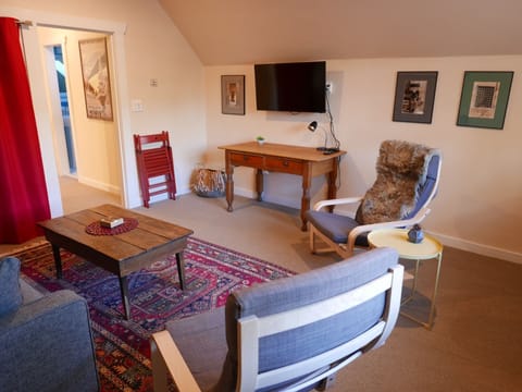 lots of natural light in living room  with new large flat screen