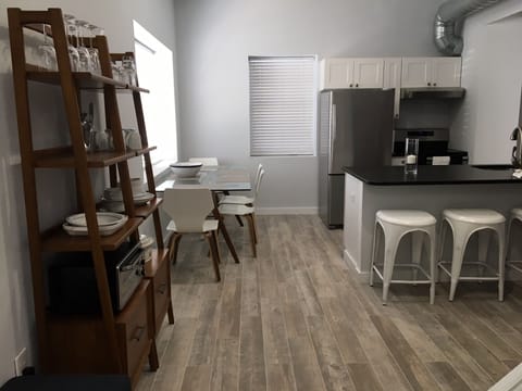 Standing in the doorway, the full kitchen and counter area…and table!