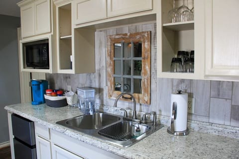 Keurig coffees and creamer along with snack and wintered water.