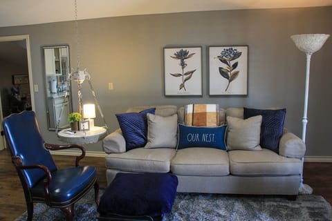 Comfy living space with kitchenette and large smart tv.