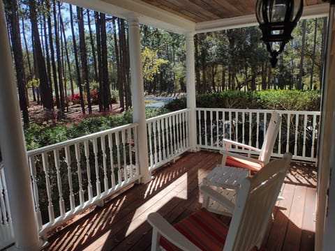 Front porch with rocking chairs, swing, and privacy within the pine trees