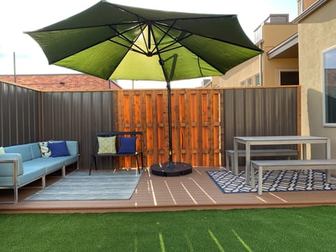 Back deck. Umbrella can swing to cover all spots of the deck. 