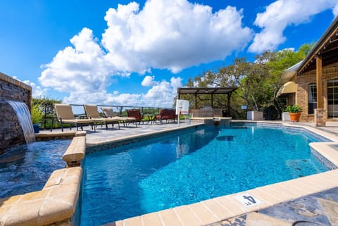 The pool also contains a waterfall and basketball hoop.