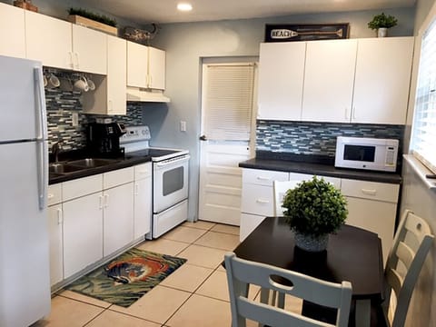 Kitchen and door leading to laundry room and side patio