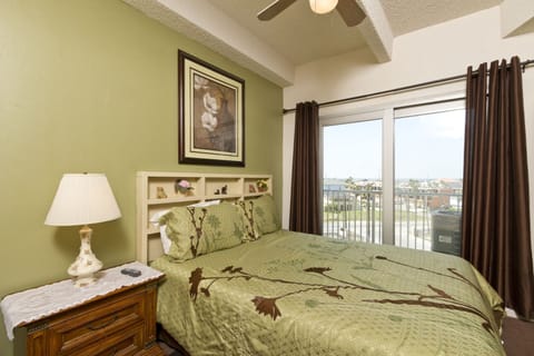 The primary bedroom is very comfortable with a queen-size bed and has a sliding door with access the balcony.