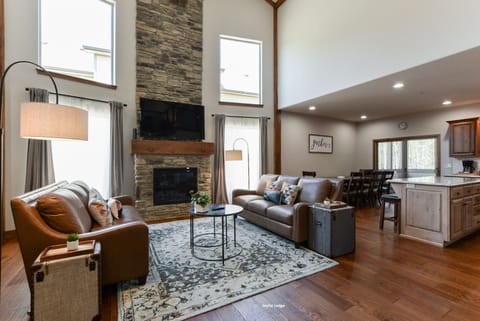 Living room showcase floor to ceiling stone fireplace leather sofas #Joyfullodge