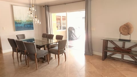 Dining area with pool and water view.