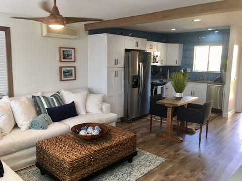 Living room
well appointed kitchen.
Table and two upholstered chairs.