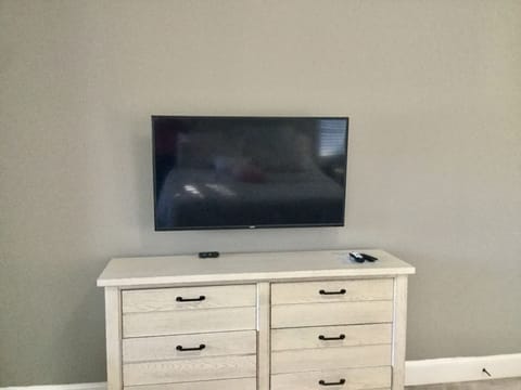 Master bedroom w/ NEW 50 inch Flatscreen TV mounted on wall