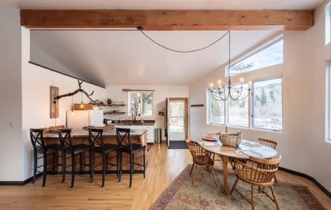 Spacious dining and kitchen area with expansive views of the river and mountain