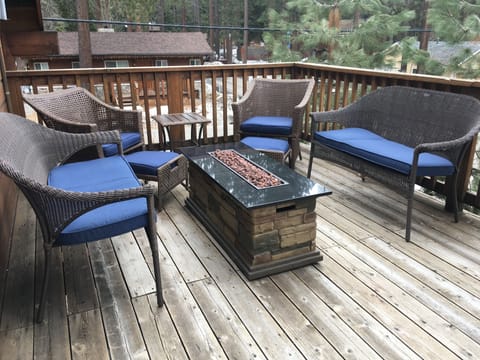 fire table to enjoy with friends on upstairs deck overlooking trees
