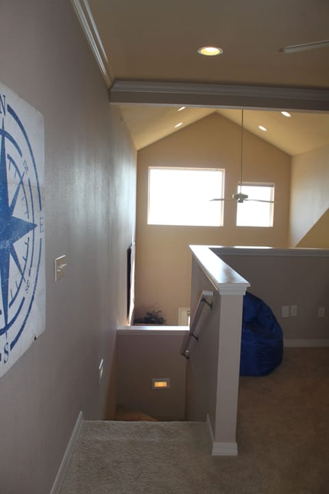 Loft Bedroom stairway showing open wall area. Privacy shade rolls down to ledge!