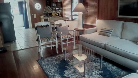 Living room has two sofas and extra chairs. 