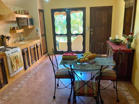 Kitchen, door entry, entry to balcony, and dining table