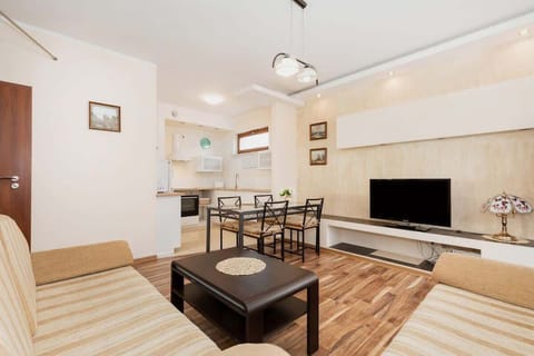 A bright living room with natural light streaming through the windows, highlighting the warm tones of the furniture.