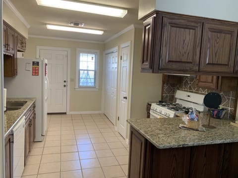 Back entry off of the kitchen leads to the patio in the private back yard