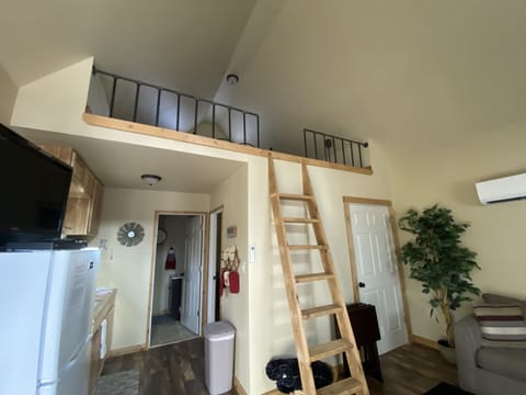 living room showing large open loft that has a queen bed