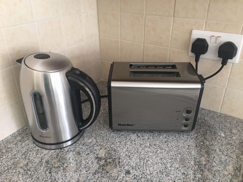 Fridge, stovetop, electric kettle, cookware/dishes/utensils