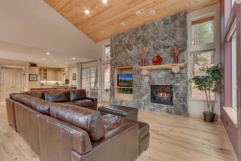 - Open concept living with stone fireplace feature
- Leather sectional perfect for family gatherings
- Tahoe rental home with warm rustic mountain charm