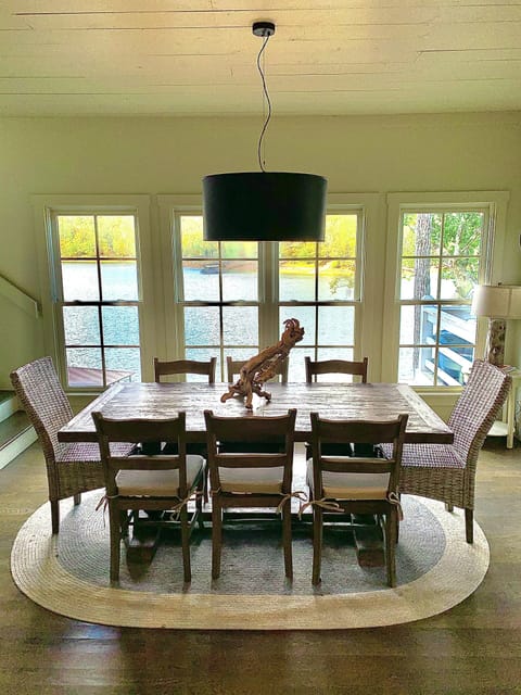 Custom farm table made for this house that sits 8 with floor to ceiling windows!